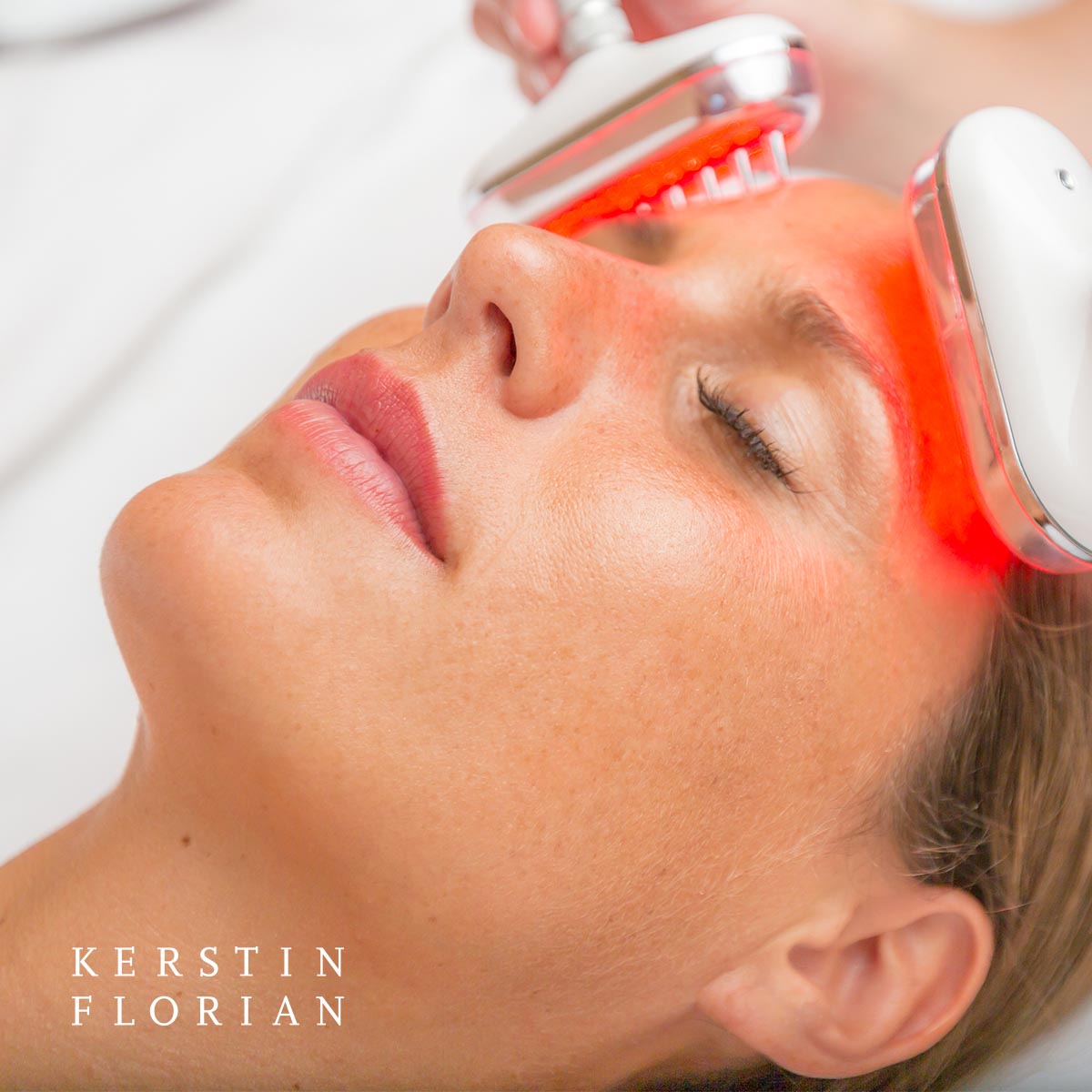 a woman receiving a facial massage in a salon