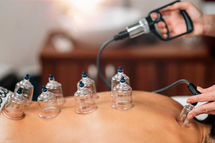 a woman receiving a facial massage in a salon