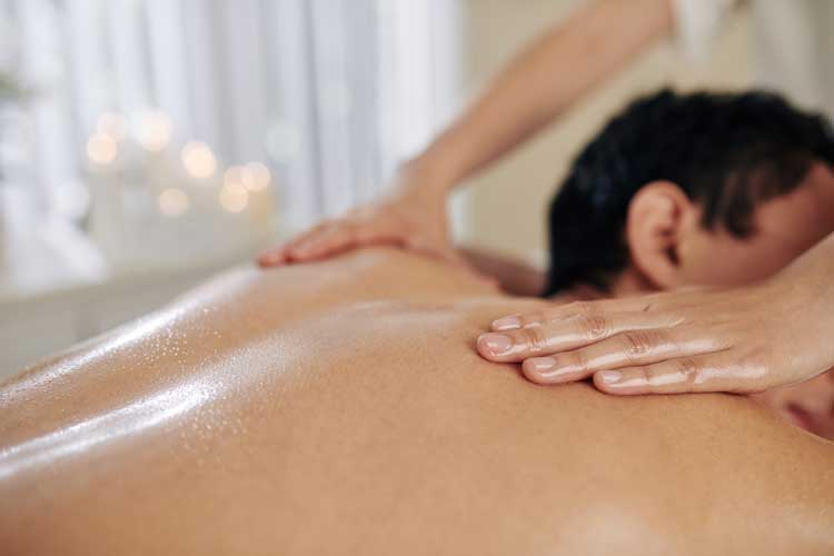 a woman receiving a facial massage in a salon