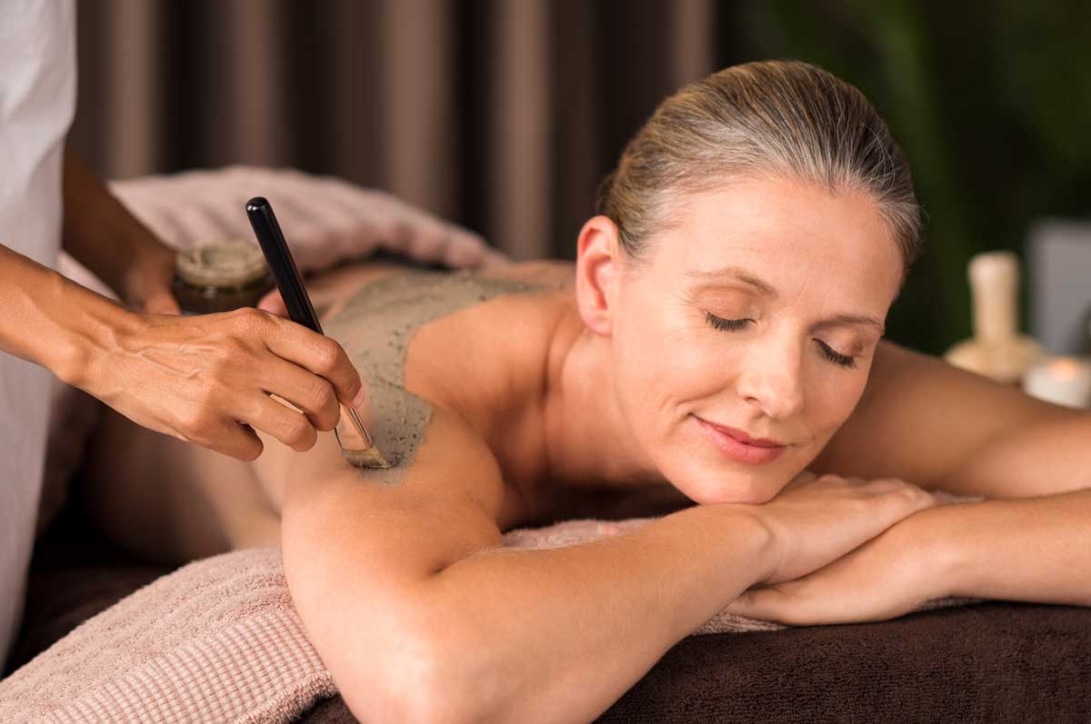 a woman receiving a facial massage in a salon